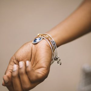 Close-up of an adult woman's hand adorned with stylish bracelets highlighting elegance.